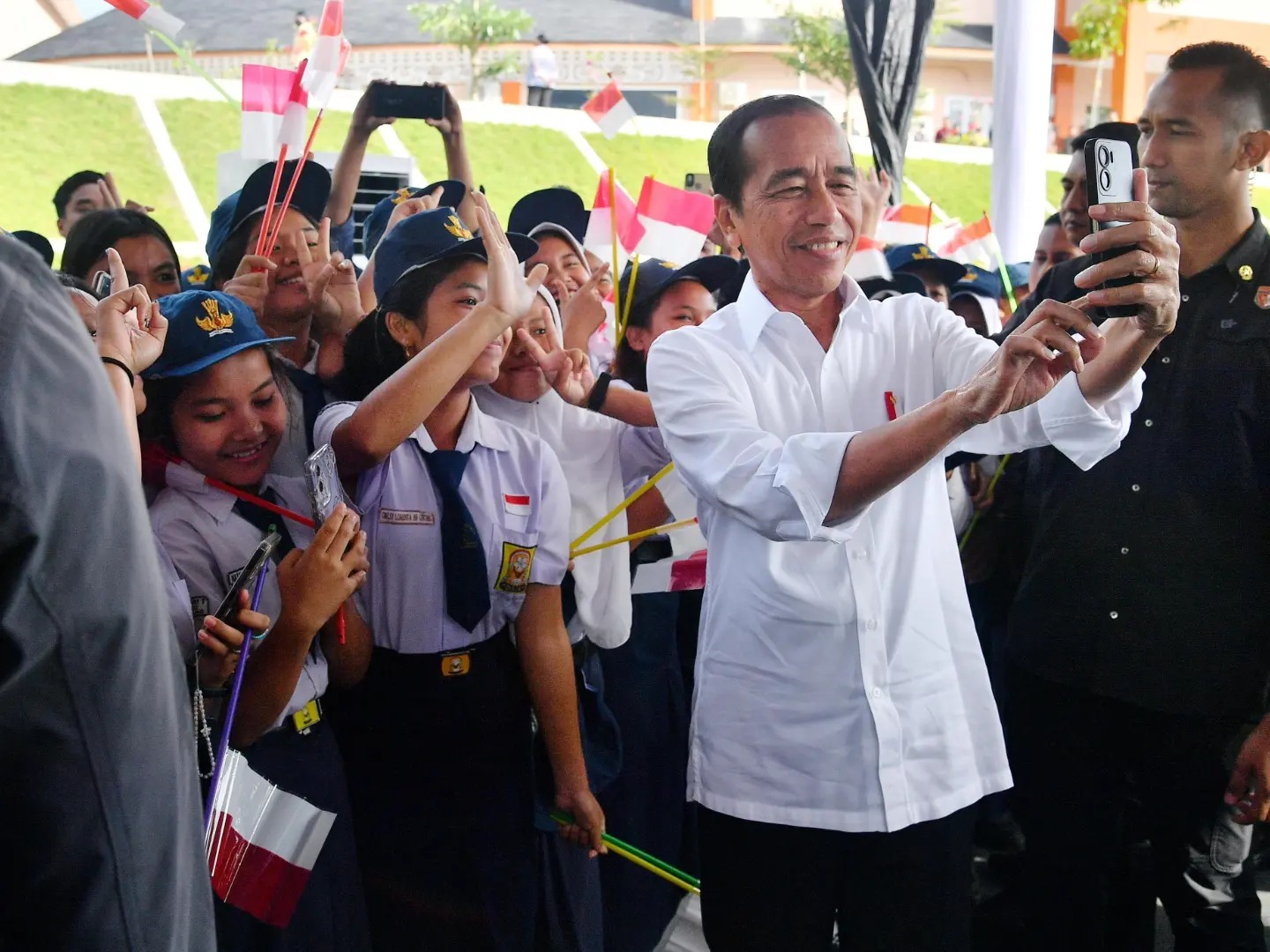 Indonesian president Joko Widodo takes a selfie with children. He has sparked a global debate on dynastic politics. Photo: Facebook/President Joko Widodo