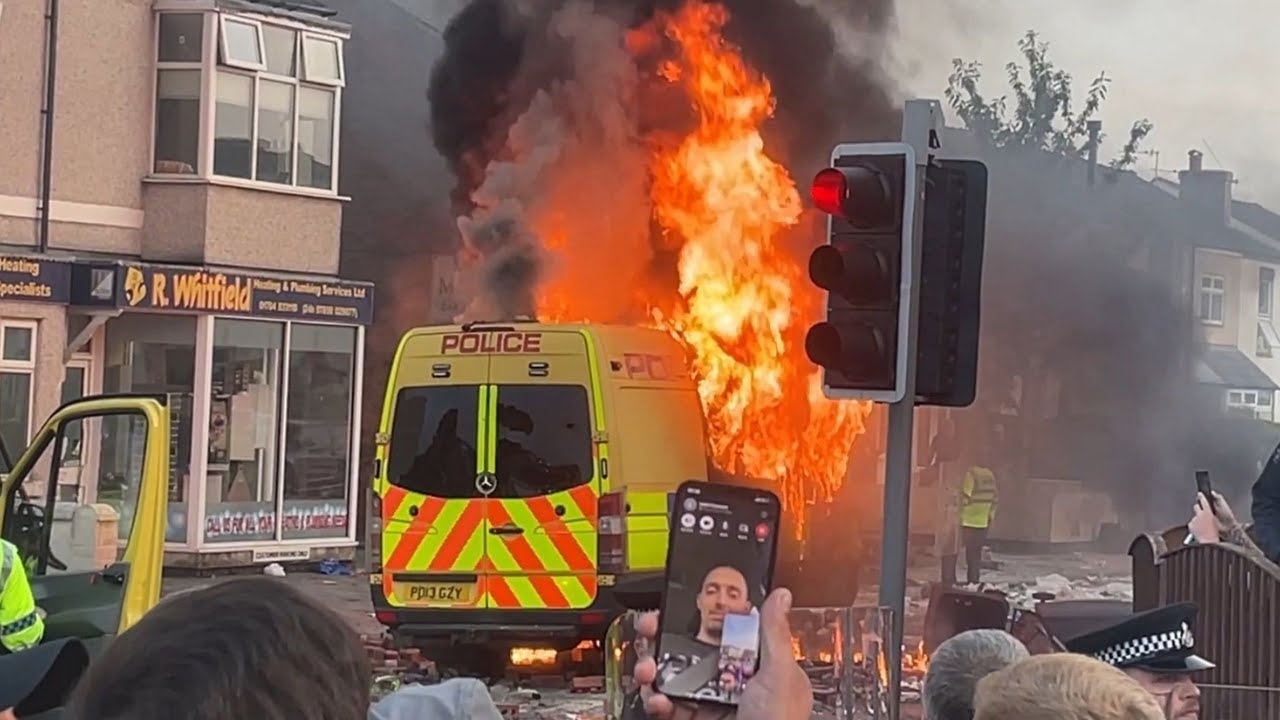 Mobs set a van on fire during August riots in Southport city in the UK. Photo: StreetMic LiveStream via Wikimedia Commons