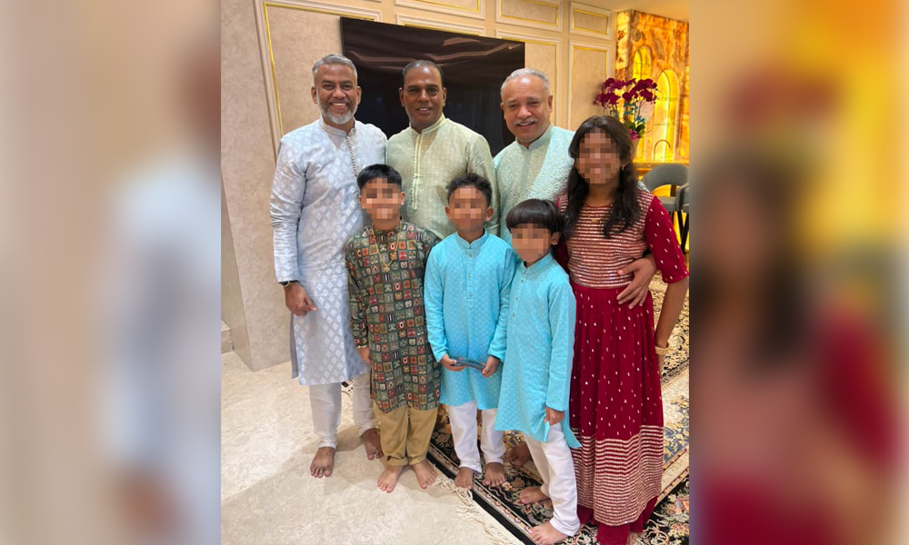 Ex-human resources minister M Saravanan in between Aminul and HRD Corp CEO Shahul Hameed Shaikh Dawood (left), with some family members, at Saravanan’s home