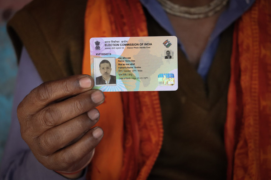 Das holds up his voter ID card ahead of the Delhi Assembly elections, a milestone in his journey as a newly-minted citizen under the CAA law. 