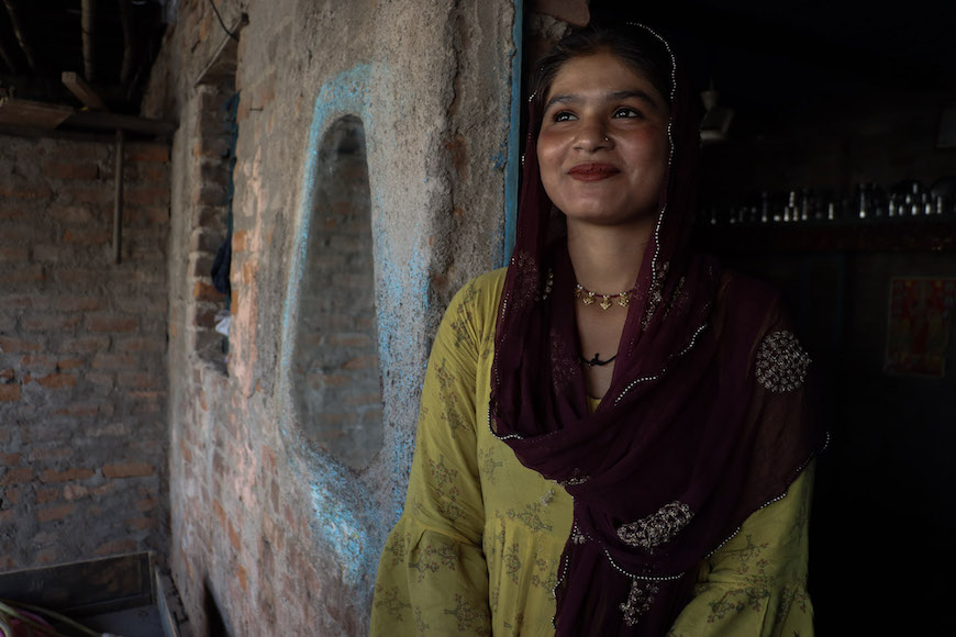Rajkumari Gulab, 18, poses for a portrait inside her makeshift home inMajnu Ka Tilla refugee colony. Photo: Shivalika Puri