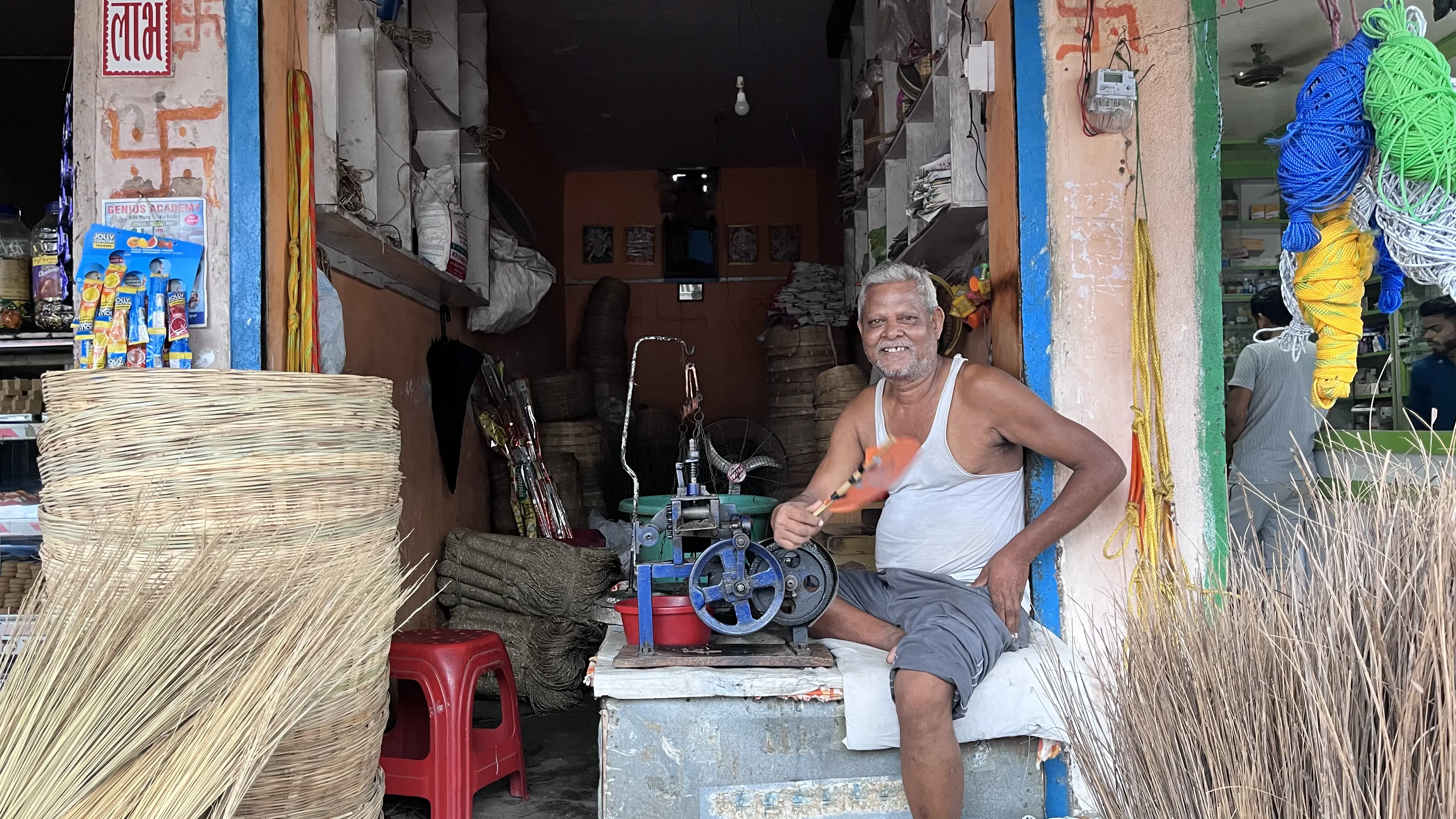 Kapil Dev Prasad sits outside his establishment and looks at the camera. He has given up Husk Power's connection because he found it expensive. Photo: Sneha Richhariya
