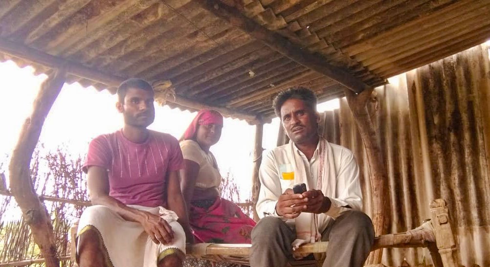Rajesh Damor (seated on the right) with his neighbours in Sukhwara panchayat. He speaks Bhili, Wagdi, Mewari, Gujarati and Hindi, the last helped him negotiate with the contractor when their dues of over Rs. two lakh were held back in Morbi in Gujarat. Photo: PARI