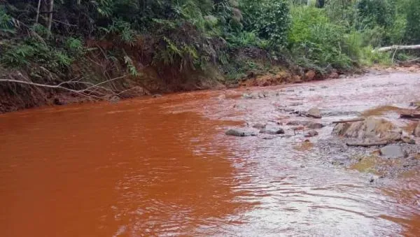 A river with red water in Kampung Kelaik, located directly downstream from the mines. Photo: Kampung Kelaik villagers via Malaysiakini
