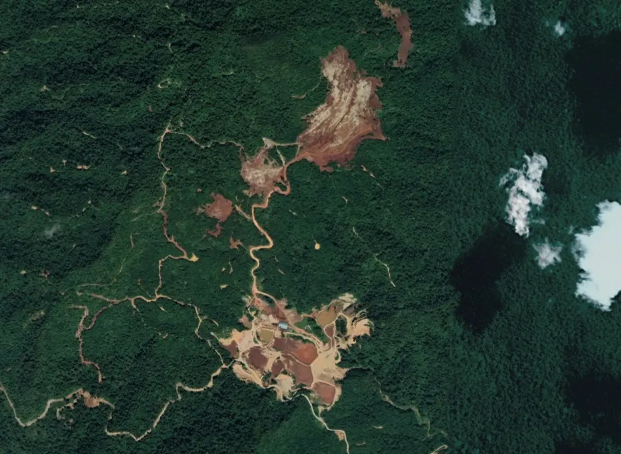 Satellite image from 2023 shows how iron ore mining has ravaged pristine rainforests, home of the Temiar folk of Kampung Kelaik near Gua Musang. Image: Malaysiakini