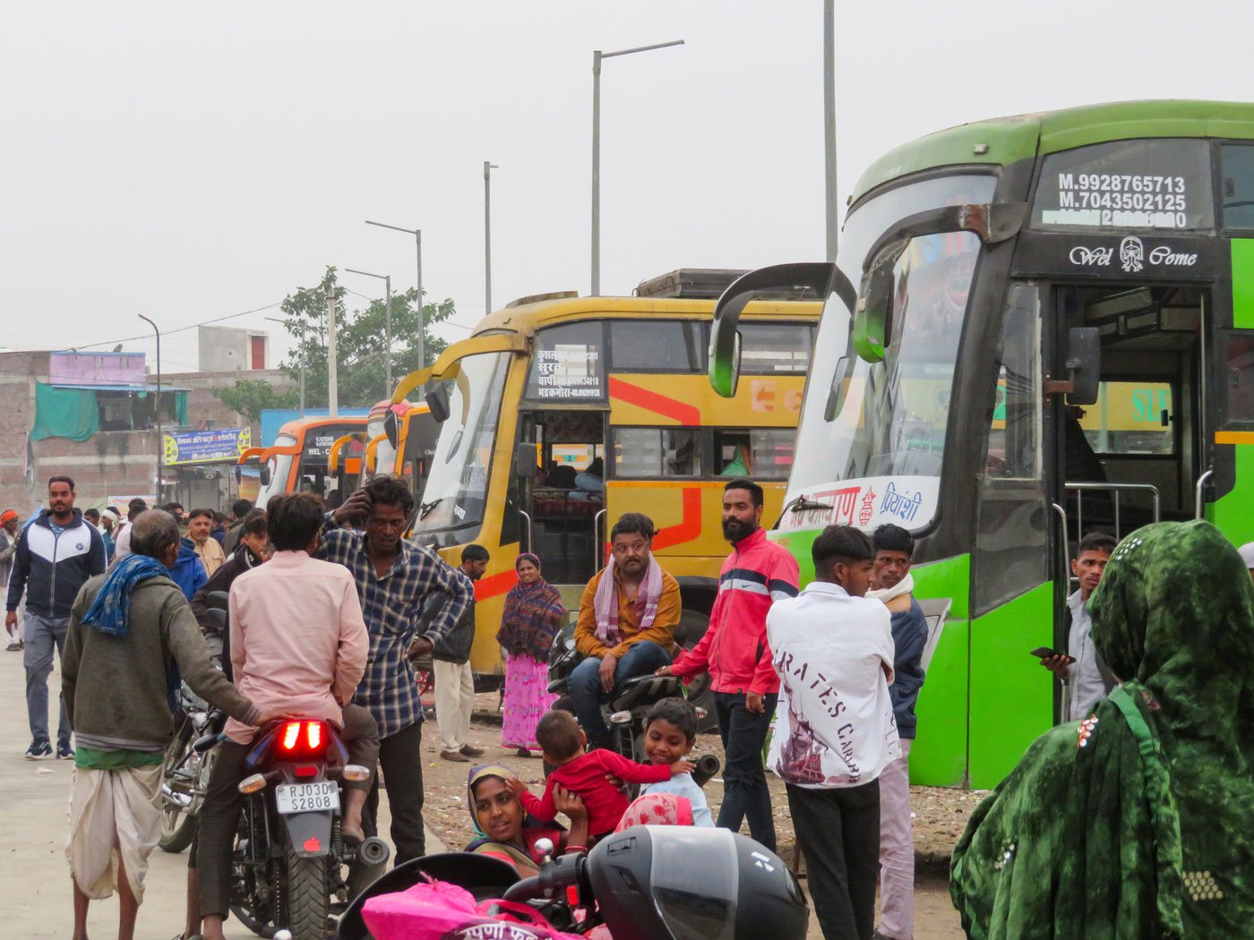 At the Timeda bus stand in Kushalgarh, roughly 10-12 busses leave every day for Surat and big cities in Gujarat carrying labourers – either alone or with their families – looking for wage work. Image shows the crowd at the bus stand. Photo: Priti David/PARI