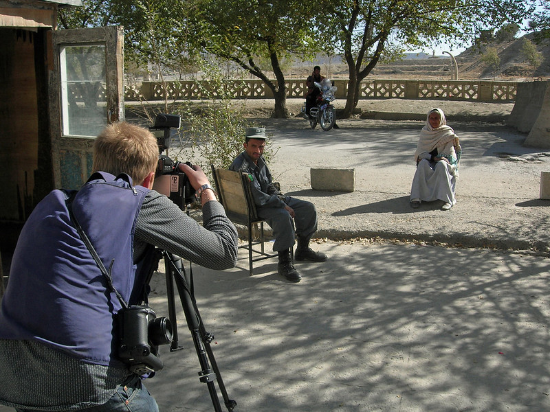 Representative image of a photojournalist focusing their camera lens on an Afghan woman. Photo: Carl Montgomery via Flickr