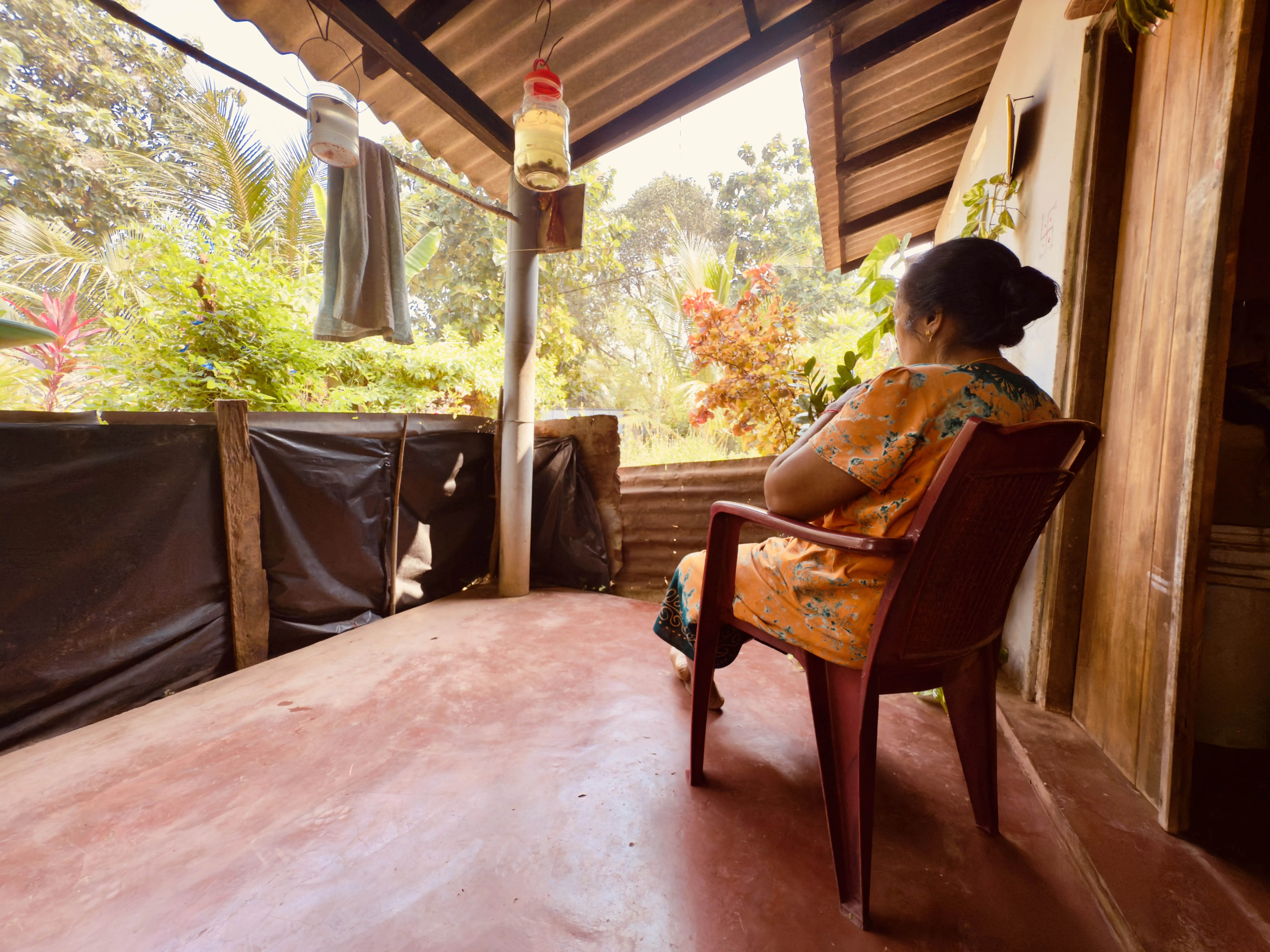 Pulasthi looks out at the expanse of land beyond the confines of her humble home. Photo: Rukshana Rizwie