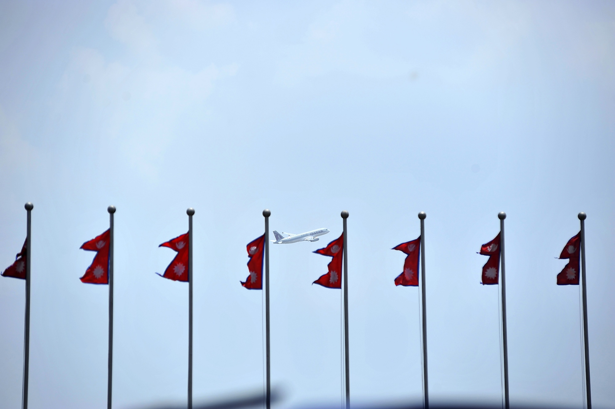 The image shows a Qatar Airways flight departing from Kathmandu.