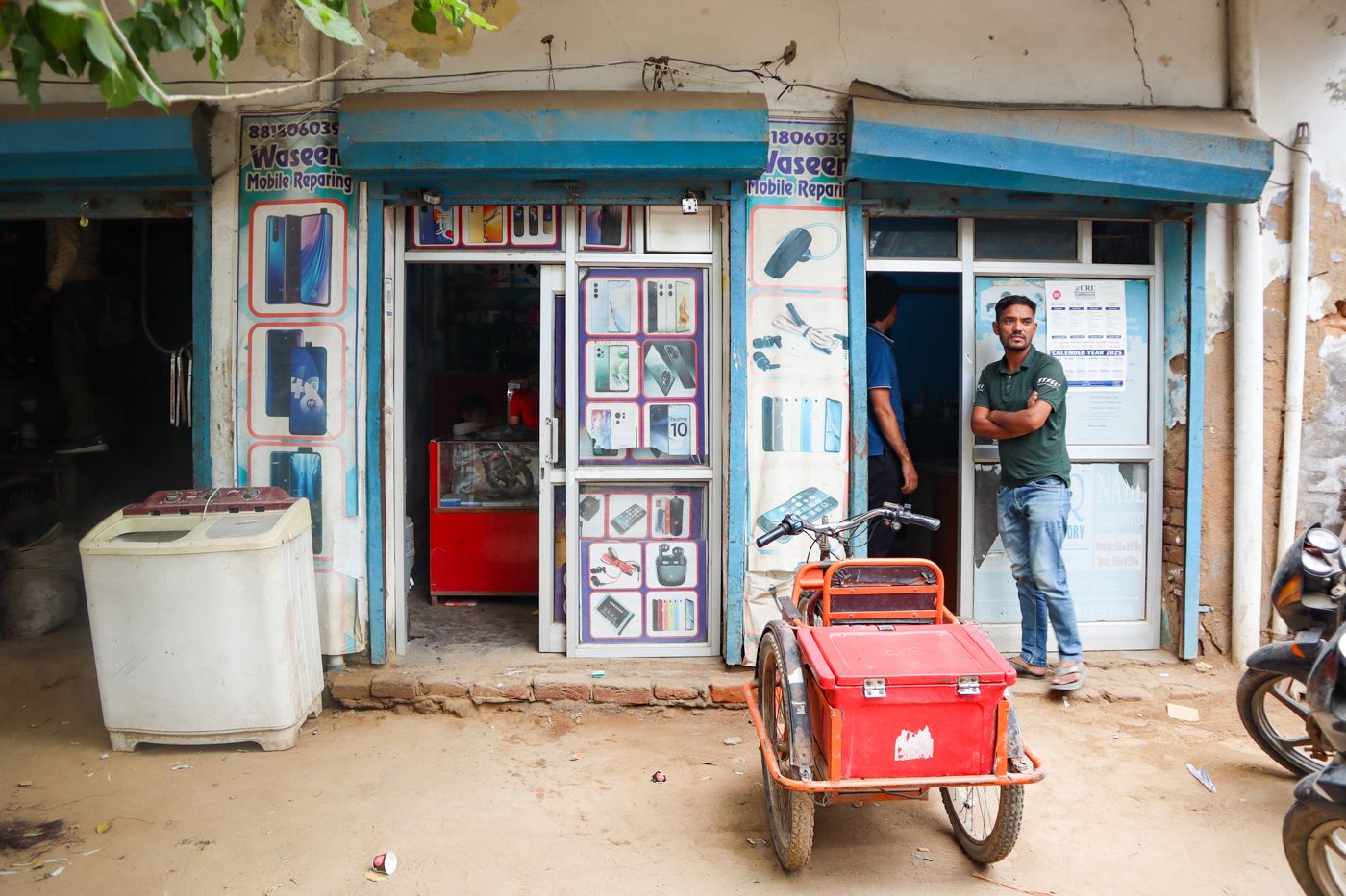 The image shows Waseem's mobile repair shop.