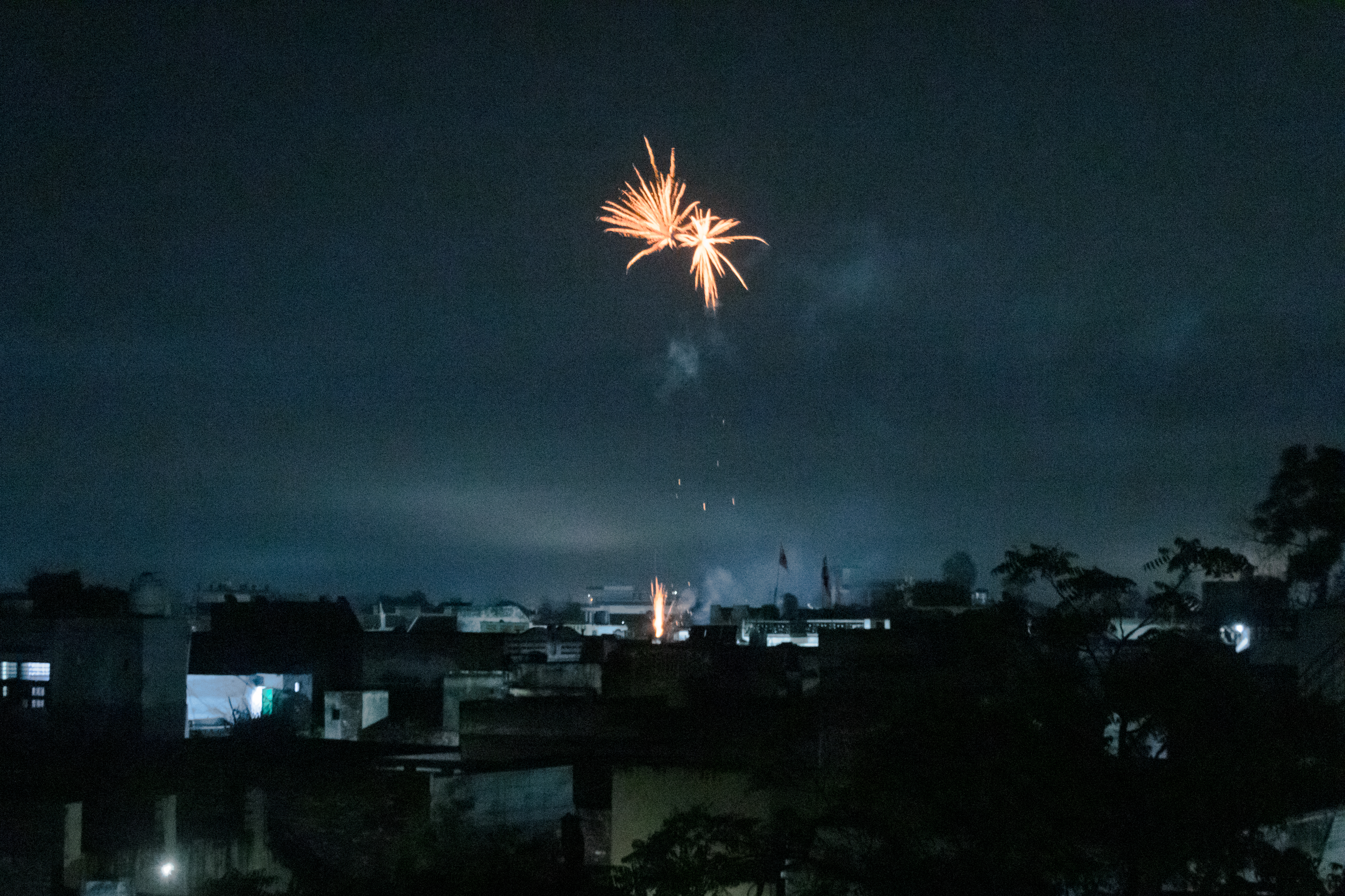 This image shows firecrackers being burst by family members of those who have reached their destination via the dunki route. 